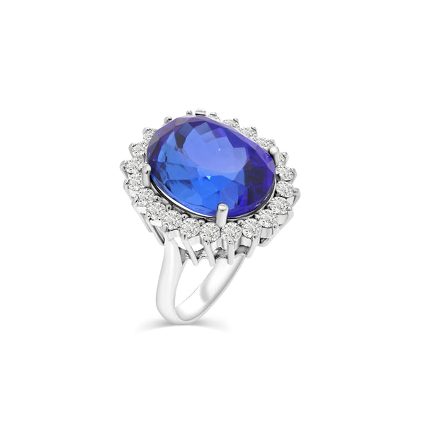 ELEGANT RING FEATURES A DEEP BLUE OVAL CUT TANZANITE IN 18K WHITE GOLD